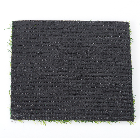 Underside of an artificial grass sample showing the backing and stitching