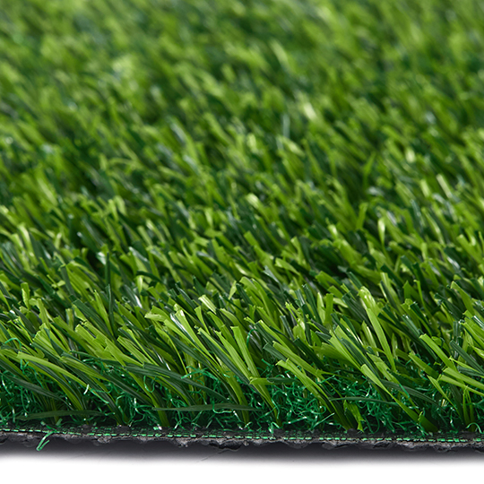 Side view of artificial grass blades above the backing