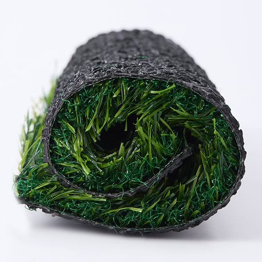 Rolled artificial grass showing the fibers and backing
