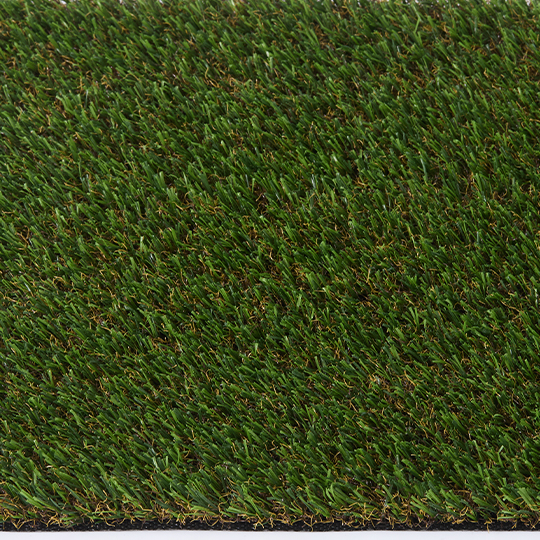 Top-down close-up of dense green turf with scattered tan fibers