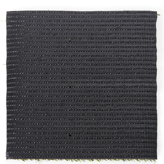 Underside of a square turf sample, showing dark backing and rows of stitching