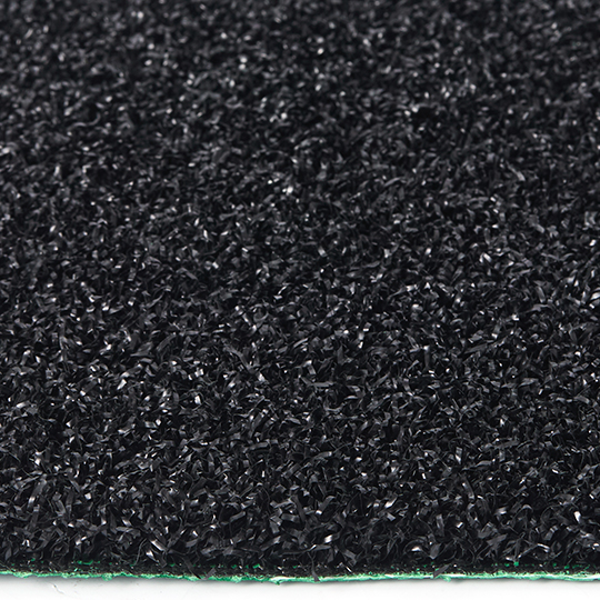 Hyrox turf close-up showing dense black synthetic fibers