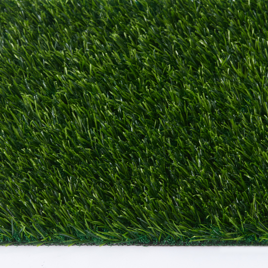 Close-up of dense artificial turf viewed from above, with the sample edge visible