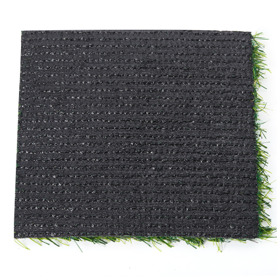 Square turf sample shown from underneath with dark backing and rows of stitching