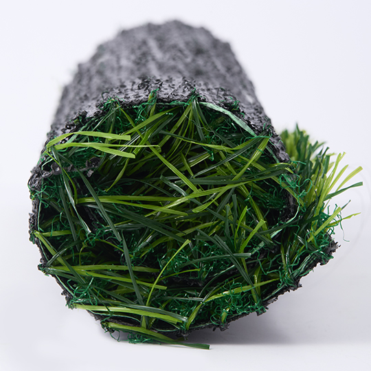 A rolled piece of turf with fibers and backing visible at the opening